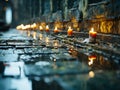 candles are lit on a street in the rain