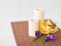 Candles, orchid and iris flowers on bamboo mat Royalty Free Stock Photo