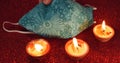 Candles and an ornamented face mask on the red surface; Divali festival in lockdown