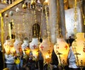 Candles and pilgrims at The Stone of Unction in The Church of the Holy Sepulchre Royalty Free Stock Photo