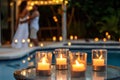 candles on poolside tables, couple dancing in background Royalty Free Stock Photo