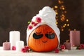 Candles and pumpkin with eye patches on brown background Royalty Free Stock Photo
