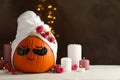 Candles and pumpkin with eye patches on brown background Royalty Free Stock Photo