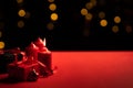 Candles and red gift boxes on a special romantic day and bokeh