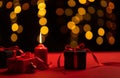 Candles and red gift boxes on a special romantic day and bokeh