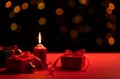 Candles and red gift boxes on a special romantic day and bokeh