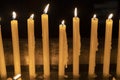 Candles on a row lit inside a church Royalty Free Stock Photo