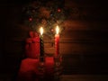 Candles and Santa bag with Christmas decorations in dark interior Royalty Free Stock Photo