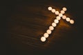 Candles in shape of cross on table Royalty Free Stock Photo
