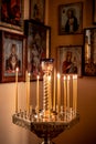 Candles shine in front of the icons in the church