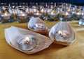 Candles in small glasses and boats during the vigil ceremony and prayer