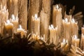 Some burning wax candles that are melted in the Holy Week of Seville Royalty Free Stock Photo