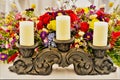 Candles on a stand and floral arrangement Royalty Free Stock Photo