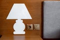 A candlestick by the bed with a socket in the wall Royalty Free Stock Photo