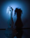 Candlestick with an almost burnt-out extinguished candle and dripping wax in the dark, illuminated by a blue light Royalty Free Stock Photo