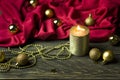 Candlestick, candles and Christmas decorations on snow against the background of a wooden board. Christmas background, greeting