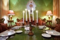 Candlestick with candles at table with serving Royalty Free Stock Photo