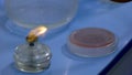 Candlestick with fire on laboratory table. Royalty Free Stock Photo