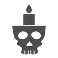 Candlestick in head solid icon. Candle in scary scull. Halloween party vector design concept, glyph style pictogram on Royalty Free Stock Photo