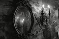 Candlestick and mirror on the wall. Black and white photo. Royalty Free Stock Photo
