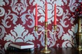candlestick with red candle near books