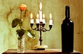 A candlestick a rose is an excellent bottle of red wine Royalty Free Stock Photo