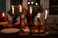 Candlesticks with candles on wooden table.romantic setting for dinner in kitchen Royalty Free Stock Photo