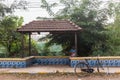 A bicycle parked outside a vintage bus stop in the village of Sinquerim