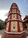 A colorful pillar with carvings of Hindu deities at an ancient temple in Sinquerim