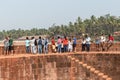 Crowd of Indian tourists at the Portuguese era fort in Sinquerim