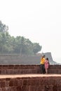 An Indian romantic couple taking a selfie on the walls of the ancient coastal fort in