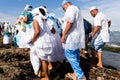 Candomble members are seen standing on the rocks of Rio Vermelho beach to offer gifts to Yemanja