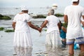 Candomble people enter the waters of Rio Vermelho beach to offer gifts to Yemanja