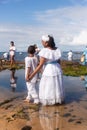Candomble people enter the waters of Rio Vermelho beach to offer gifts to Yemanja