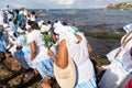 Candomble supporters walk on top of the rocks on Rio Vermelho beach to offer gifts to Yemanja