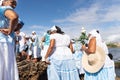 Candomble supporters walk on top of the rocks on Rio Vermelho beach to offer gifts to Yemanja