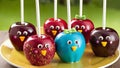 Candy apples with funny faces and drinking straws