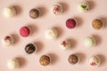Candy background. Assorted truffles or energy balls on a pink background. Sweets pattern. Top view Royalty Free Stock Photo