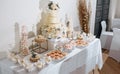 Candy bar at the banquet. Wedding table with sweets, cake, pastries, muffins, sugar treats. Event in the restaurant