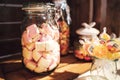 Candy bar. Close up of marshmallows in glass jar and bunch of lollipops. Celebration, party, birthday or wedding concept Royalty Free Stock Photo