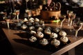 Candy Bar. Delicious sweet buffet with brown birthday cake decorated chocolate balls and number 29, cupcakes with white
