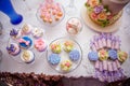 Candy bar on golden wedding party with a lot of different candies, cupcakes, souffle and cakes. Decorated in brown and purple colo Royalty Free Stock Photo