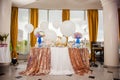 Candy bar on golden wedding party with a lot of different candies, cupcakes, souffle and cakes. Decorated in brown and purple colo Royalty Free Stock Photo