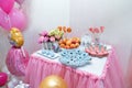 Candy bar with muffins, donuts and cake pops for girl birthday. Party balloons with princess cartoon character.