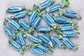 Candy Bounty mini of American company. A heap of wrapped chocolate bars with coconut on a gray background. Confectionery product Royalty Free Stock Photo