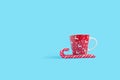 Candy cane and Christmas coffee mug isolated on blue background Royalty Free Stock Photo