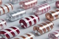 Candy Cane-A delightful array of striped chocolates in colorful foil wrappers on a white surface Royalty Free Stock Photo