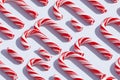 Candy Cane-A festive pattern of red and white striped candy canes on a solid white surface Royalty Free Stock Photo