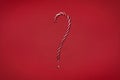 Candy cane question mark on red background. Christmas striped candie