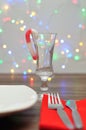 A candy cane used as a decoration in a shooter glass against an out of focus light background Royalty Free Stock Photo